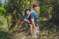 The father carries his son in a baby carrying is hiking in the f Royalty Free Stock Photo