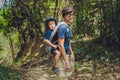 The father carries his son in a baby carrying is hiking in the forest. Tourist is carrying a child on his back in the nature of Vi Royalty Free Stock Photo