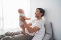 Father carry his baby boy playing together at home