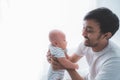 Father carry his baby boy playing together at home