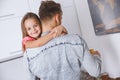 Little kid girl with father at home childhood concept making tea Royalty Free Stock Photo