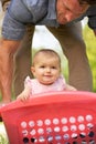 Father Carrying Baby Girl In Laundry Basket