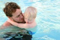 Father Carrying Child Through Water in Swimming Pool Royalty Free Stock Photo