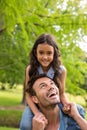 Father carrying daughter on his shoulders