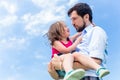 Father carrying daughter protecting her