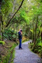 Father is carrying little daughter on his shoulders. Haast, South Island, New Zealand Royalty Free Stock Photo