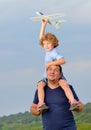 Father carrying son and his plane