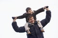 Father Carrying Son On His Shoulders