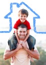 Father carrying son on his shoulders overlaid with house shape Royalty Free Stock Photo