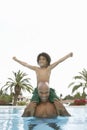 Father Carrying Son On Shoulders In Swimming Pool