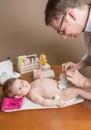 Father changing diaper of adorable baby