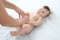 Father changing diaper on baby girl on bed, changing nappy, everyday care Royalty Free Stock Photo