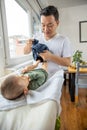 Father changing diapers to his newborn son Royalty Free Stock Photo