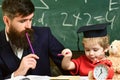 Father checking hometask, helps to boy, son. Hometask concept. Enthusiastic kid studying with teacher. Teacher in formal Royalty Free Stock Photo