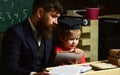 Father checking homework, helps to boy, son. Individual studying concept. Busy kid studying at school. Teacher in formal Royalty Free Stock Photo