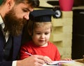 Father checking homework, helps to boy, son. Individual studying concept. Busy kid studying at school. Teacher in formal Royalty Free Stock Photo