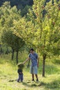 Father and child in apple orchard Royalty Free Stock Photo