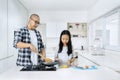 Father and child cooking together in kitchen Royalty Free Stock Photo