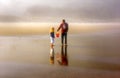 Father Child Explore Beach on Foggy Day Royalty Free Stock Photo