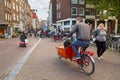 Father with a child in the freight bicycle. Amsterdam, Netherlands.