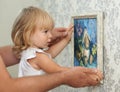 Father and child hanging picture on the empty wall Royalty Free Stock Photo