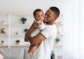 Father And Child. Happy Young Black Dad Embracing Cute Little Baby Boy Royalty Free Stock Photo