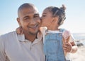 Father, child and kiss with travel and beach, family together for fun in sun, outdoor and love in portrait. Relationship Royalty Free Stock Photo