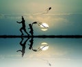 Father and child with kite at sunset