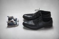 Father with Child Metaphor, baby and adult shoes