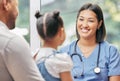 Father, child and nurse talking for health care in a hospital while happy at consultation. African woman pediatrician or Royalty Free Stock Photo