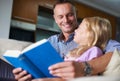 Father, child and reading a book for learning at home, story and fantasy fiction for education. Daddy, daughter and