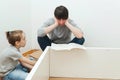 Father and child reading instruction for furniture assembly. Dad and little son assembling furniture at home Royalty Free Stock Photo