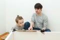 Father and child reading instruction for furniture assembly. Dad and little son assembling furniture at home Royalty Free Stock Photo