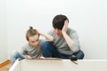 Father and child reading instruction for furniture assembly. Father helps his son to assemble a bookshelf Royalty Free Stock Photo