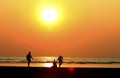 father and child by the sea shore, sunset Royalty Free Stock Photo