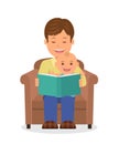 Father and child sitting in an armchair reading a book. Reading the child before bedtime. Royalty Free Stock Photo