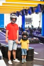 Father and child, son, preparing to ride gokart carting car race