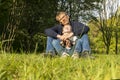 Father And Child, Son Sitting On Grass In Park, Enjoying Time Together. Summer Time Royalty Free Stock Photo