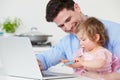 Father With Child Using Laptop At Home Royalty Free Stock Photo