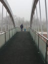 Father and child are walking in a foggy park