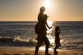 Father and children on the beach during sunset Royalty Free Stock Photo