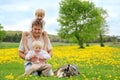 Father, Children, and Dog Relaxing in Flower Meadow Royalty Free Stock Photo