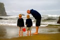 Father and Children explore Beach. Royalty Free Stock Photo