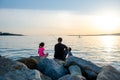 Father with children on a fishing trip by the sea. A boy and a girl with their father have fun fishing on the beach or by the sea.