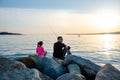 Father with children on a fishing trip by the sea. A boy and a girl with their father have fun fishing on the beach or by the sea.