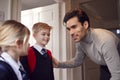 Father And Children Getting Ready To Leave Home For School In The Morning Standing By Door Royalty Free Stock Photo