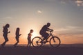 Father and children playing on the beach at the sunset time. Royalty Free Stock Photo