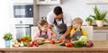 Father with children preparing vegetable salad