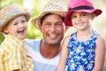 Father And Children Relaxing In Summer Garden