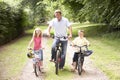 Father and children riding bikes in countryside